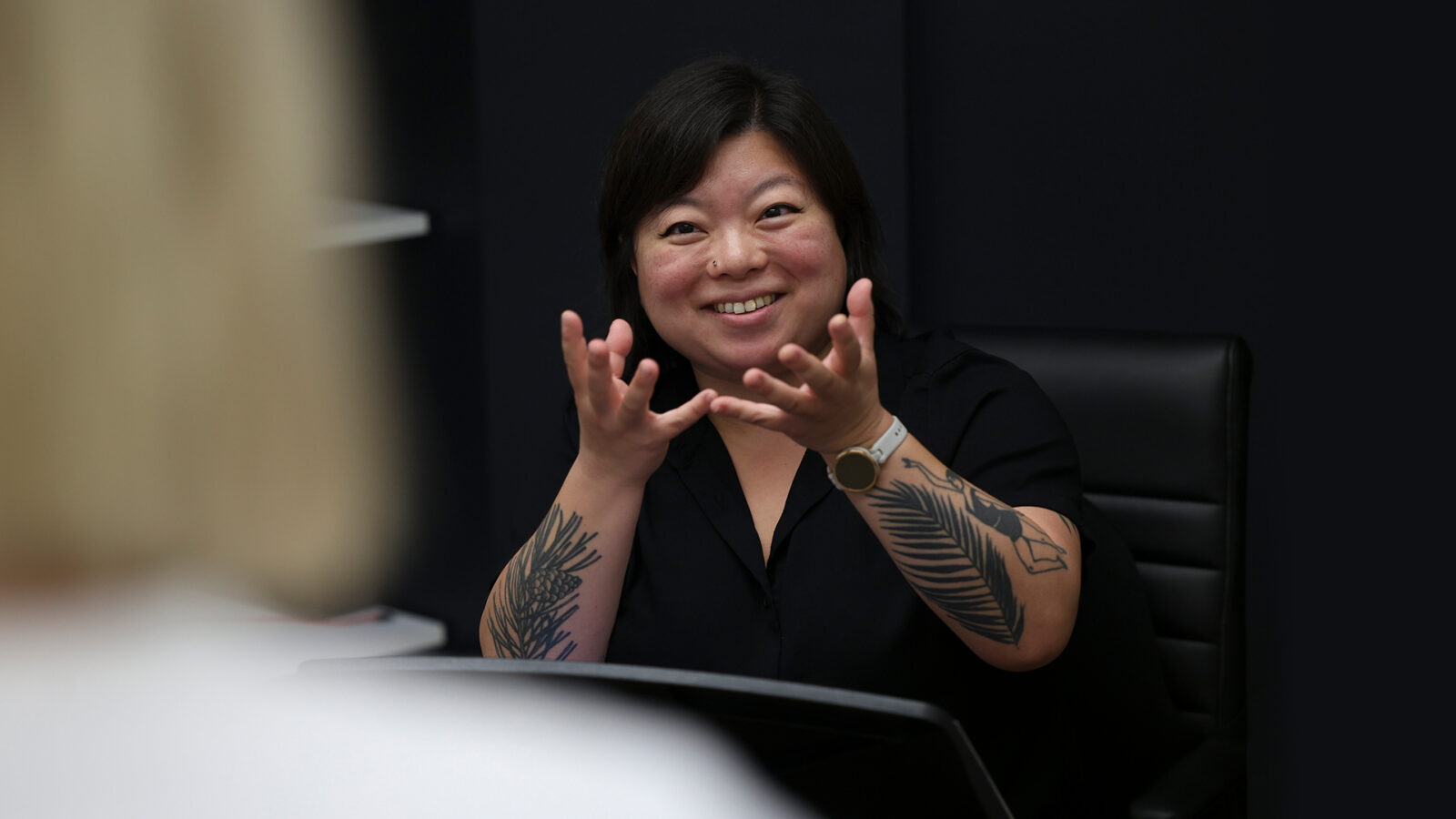 Photo of Yura Lee smiling in the classroom during a strings lesson. 