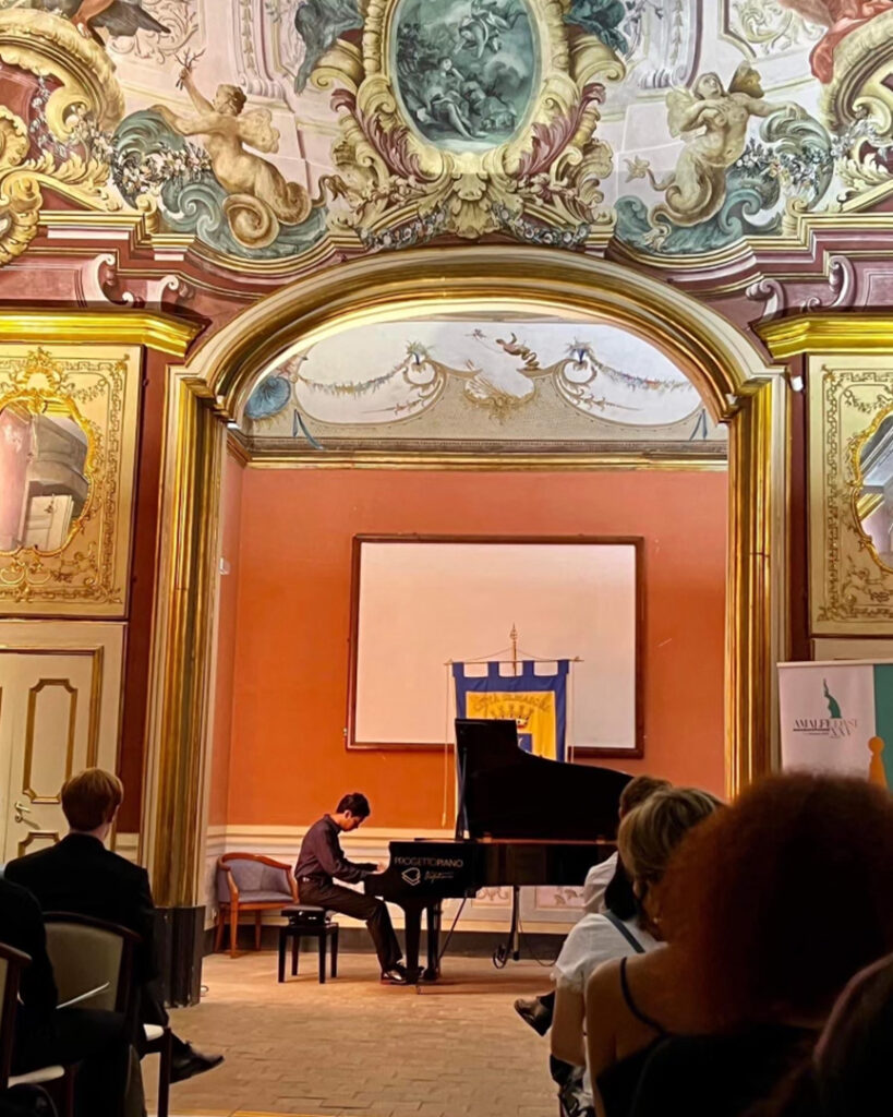 Photo of a pianist performing in a concert hall.