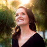 Photo of Laura Leigh Spillane looking up into the sky outside.