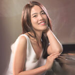Photo of Yu-Ting Peng by a piano