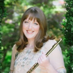 Photo of Kelly Sulick holding a wind instrument