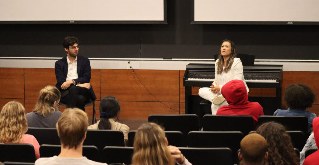 Two teachers present a lecture for their students in an indoor classroom.