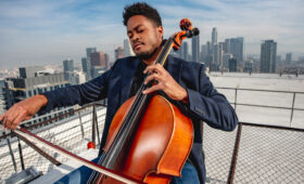 A USC Thornton cellist plays on a rooftop in Los Angeles.