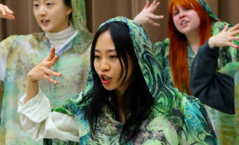 Photo of opera students rehearsing in costume.