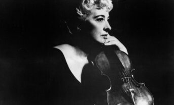 Black and white photo of Eudice Shapiro holding a violin.