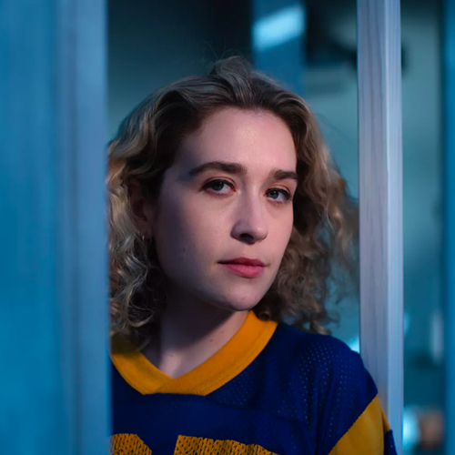 Sabrina Teitelbaum standing outdoors in a blue and yellow football jersey.