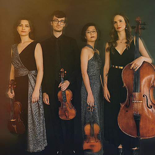 The Argus Quartet standing with their classical string instruments.