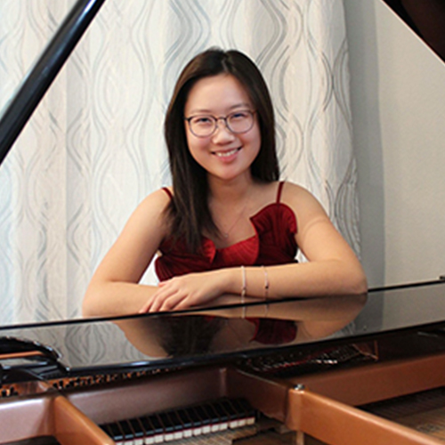 Photo of Celine Chen seated at the piano.