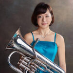 Arisa Makita with instrument wearing concert attire.