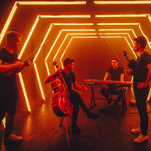 Astral Mixtape string quartet with their instruments in tunnel lit by red neon.