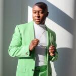 USC Thornton School of Music Dean Jason King wearing a green blazer and standing in the sunlight.