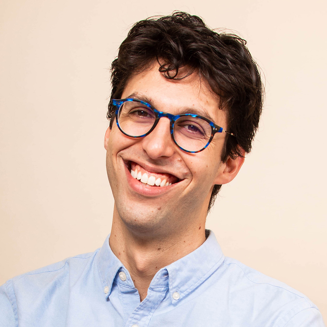 Musicologist Nate Sloan smiling and wearing glasses.