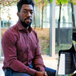 Photo of Paul Cornish sitting at the piano.