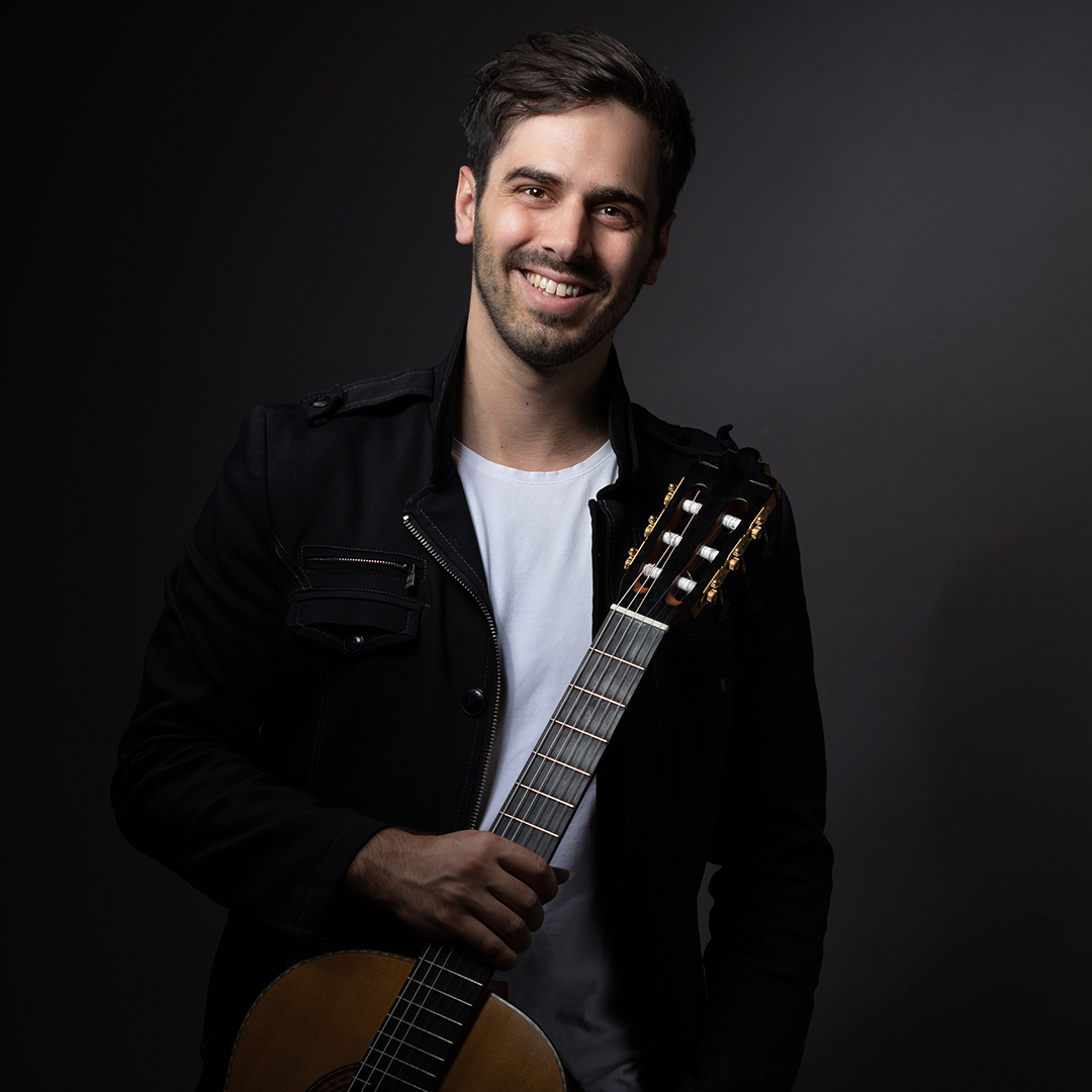 Photo of classical guitarist Mak Grgić holding a guitar.