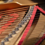 Close up of piano strings in an open piano.