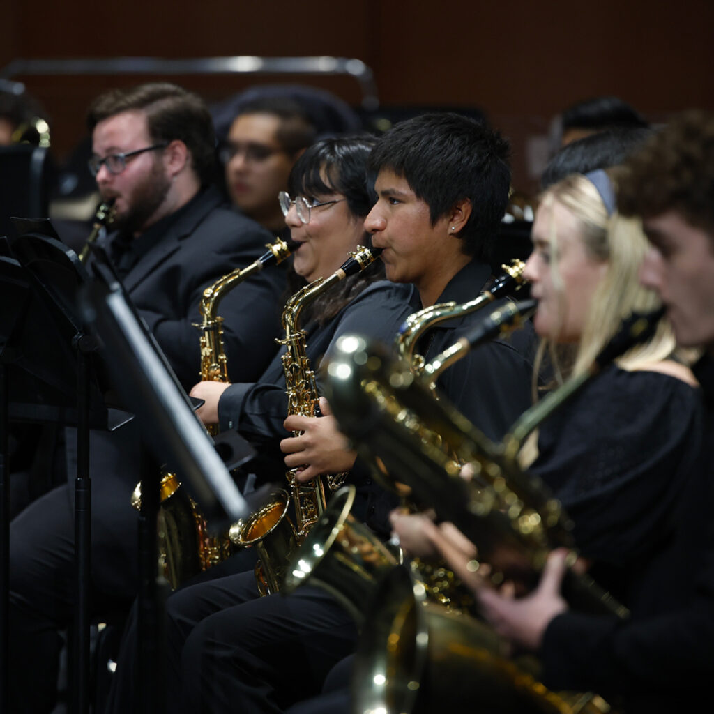 Student saxophone players perform in concert.