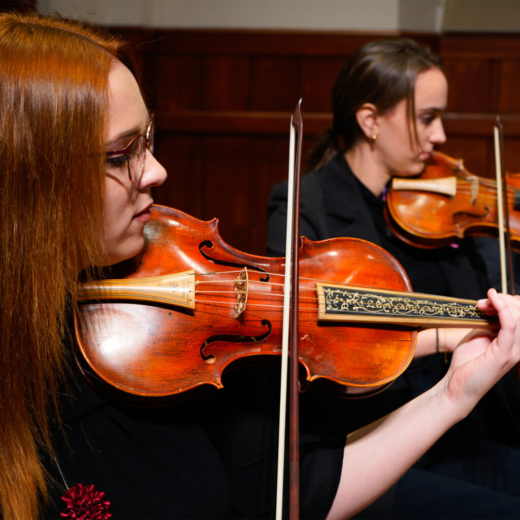 A student violinist performs in concert.