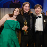 Oscar-winning composer Ludwig Göransson with Jennifer Lame and Cillian Murphy at the 96th Annual Academy Awards Governor's Ball, all holding Academy Award statuettes.