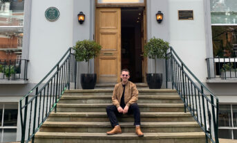 A music student sits on the steps outside of Abbey Road Studio in London.