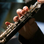 Up close photo of two hands playing the clarinet.