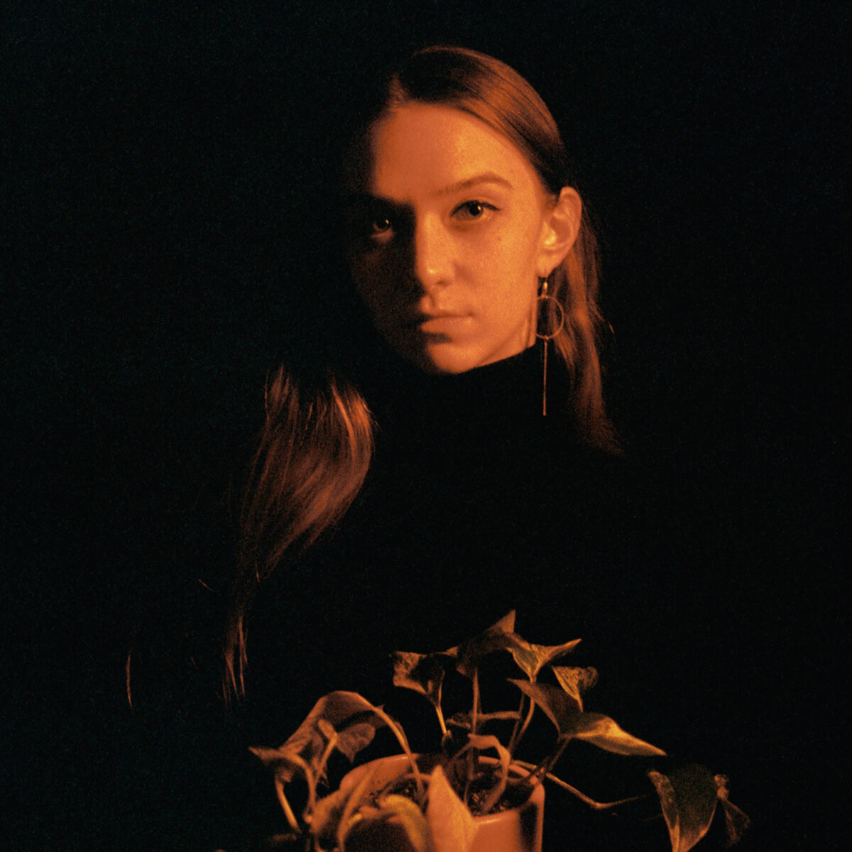 Composer Katya Richardson holding a potted plant