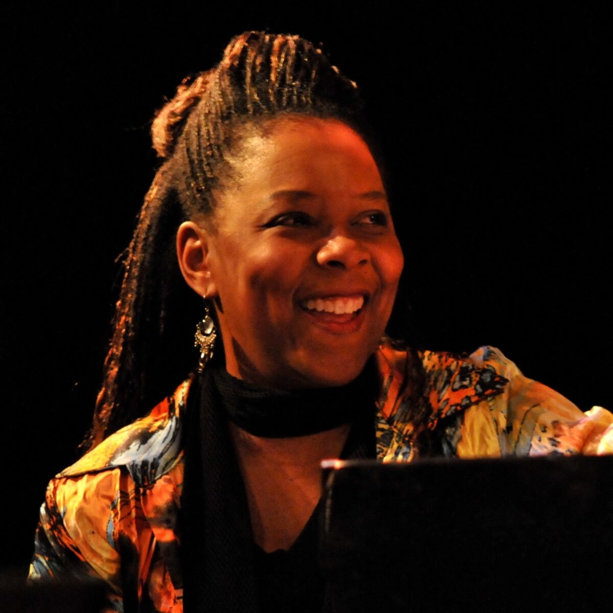 Patrice Rushen sitting and smiling at the piano