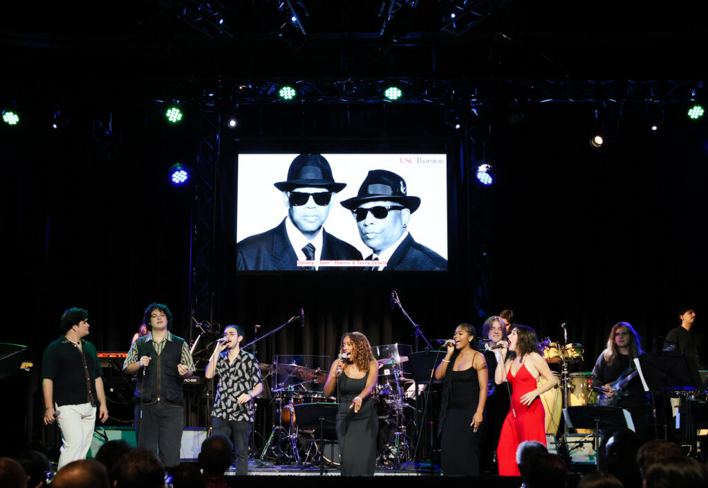 A group of student performers on stage.