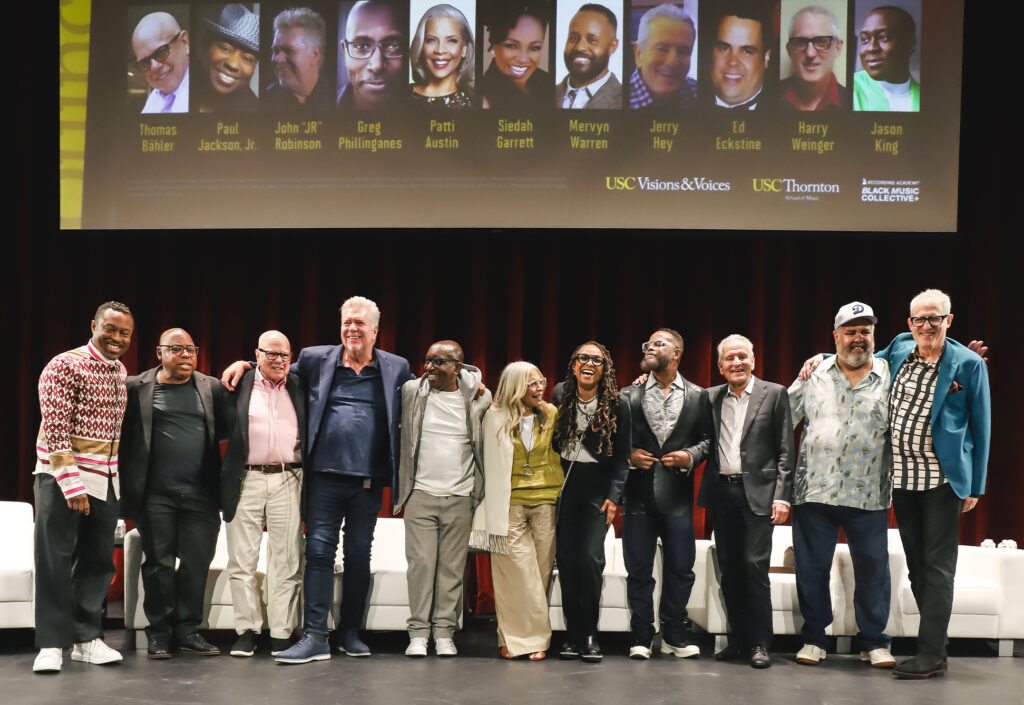 A stage full of people smiling.