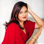Composer Raashi Kulkarni poses in red.
