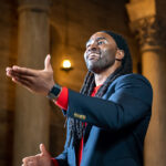 Alexander Lloyd Blake conducting a choir.