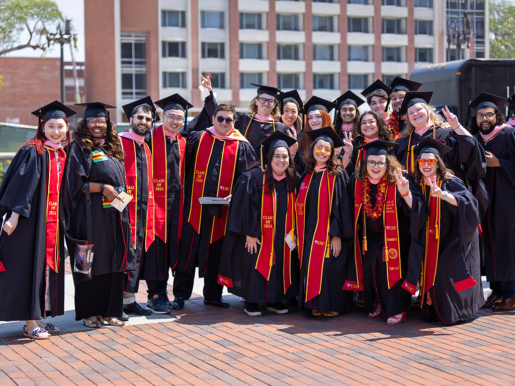 Thornton graduates pose for a photo in Commencement regalia.