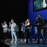 The SoCal VoCals perform onstage.