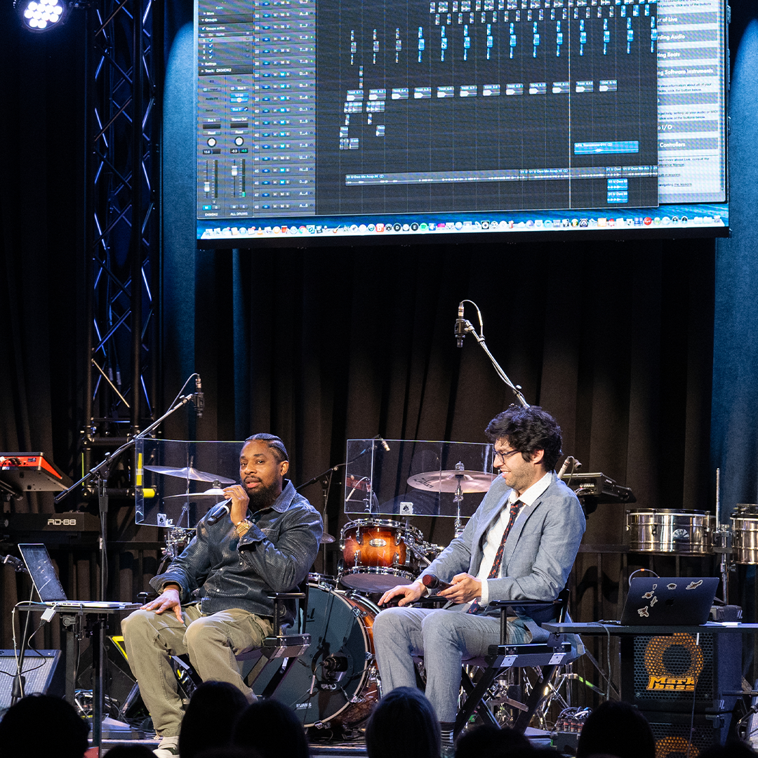 Photo of two people on a stage giving a presentation.