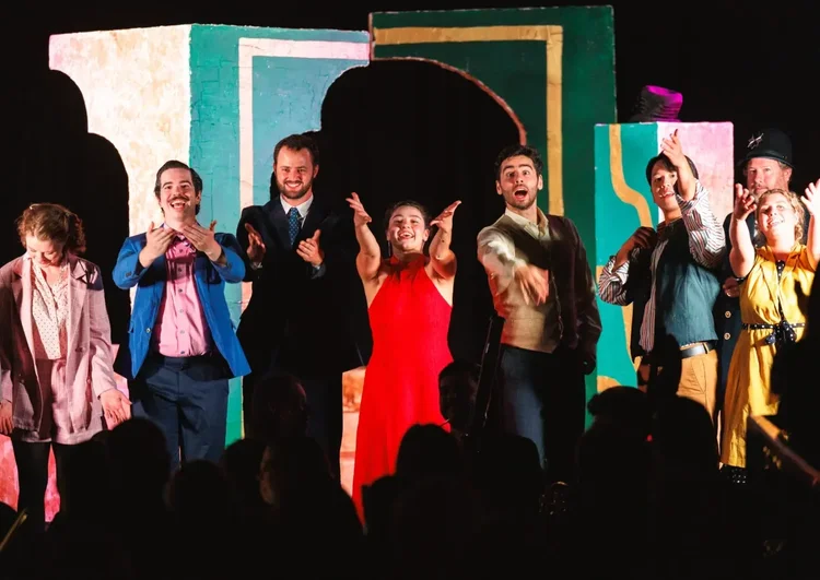 A group of people perform on stage during an Opera production.
