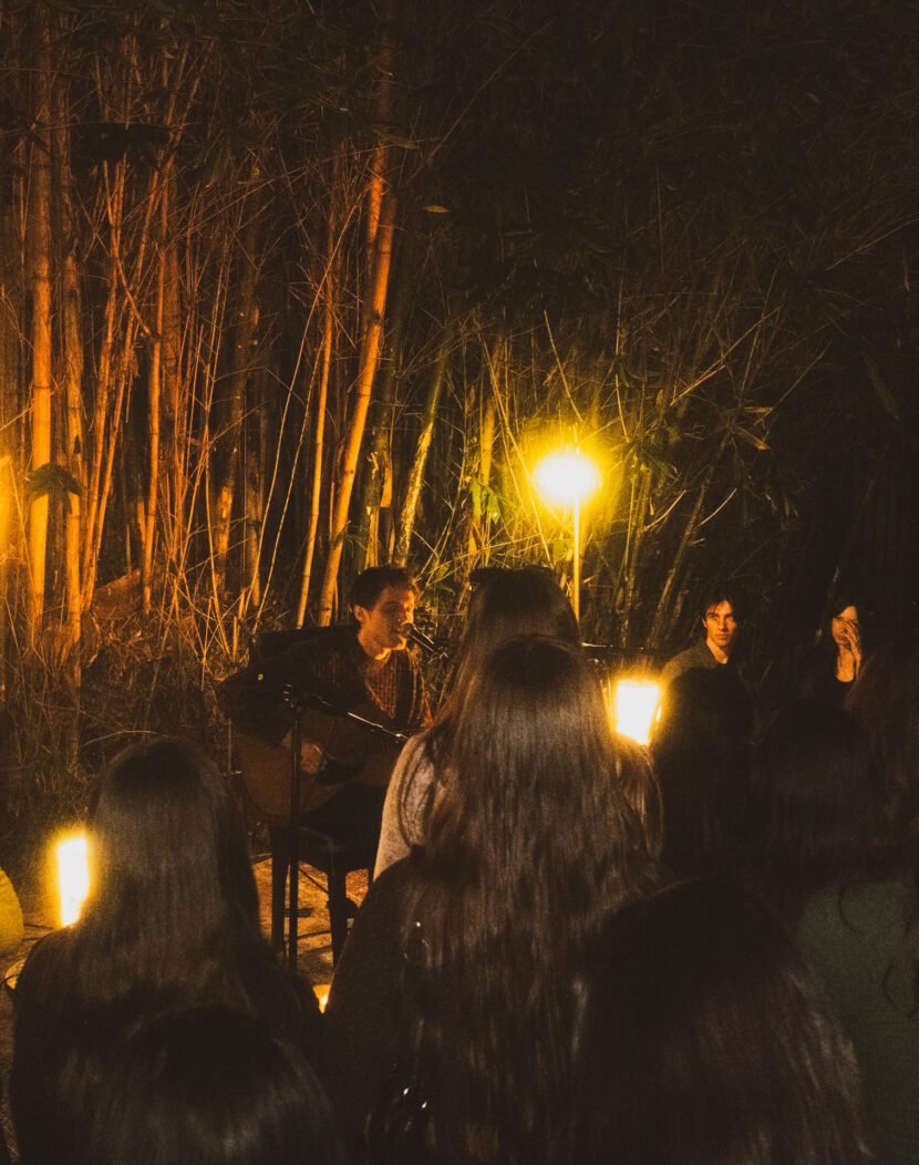 Young student performs to audience in outdoor venue.