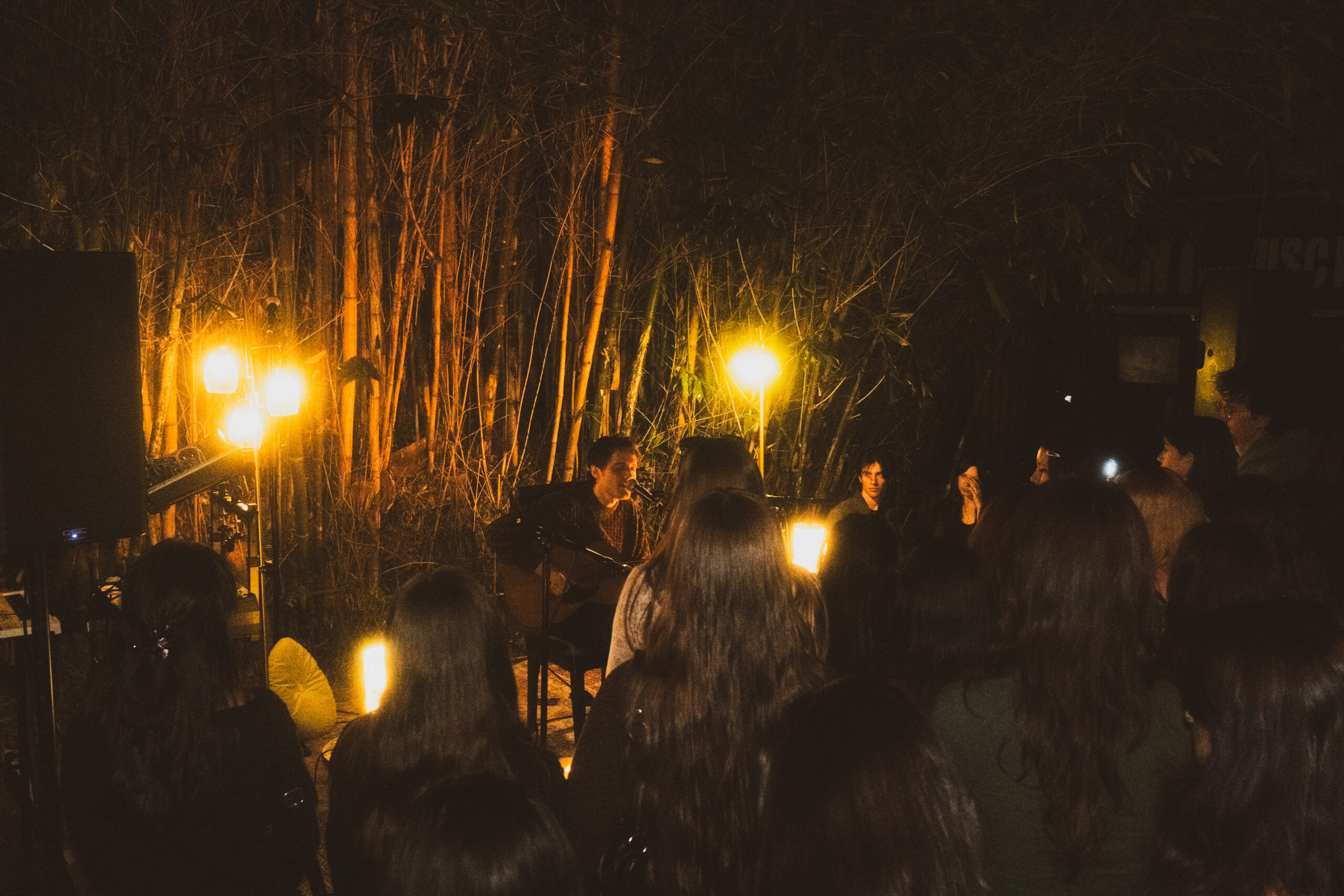 Young student performs to audience in outdoor venue.
