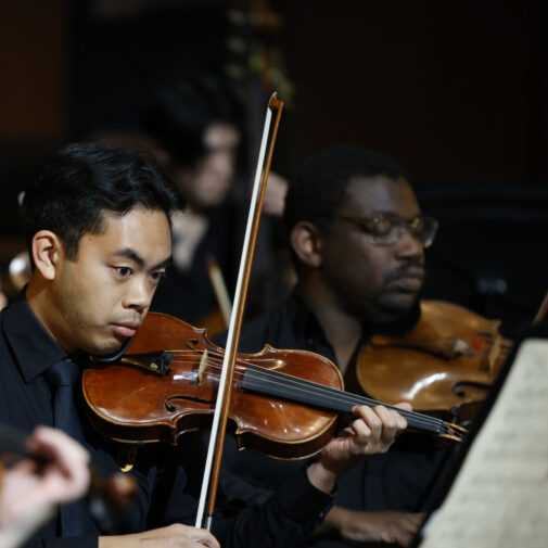 USC Thornton students play in the orchestra string section.