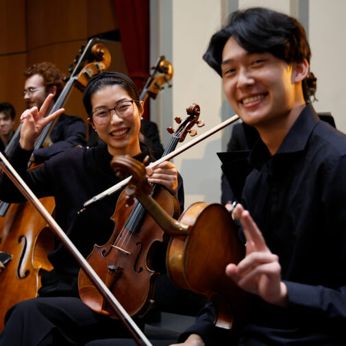 Classical strings students smiling on stage.