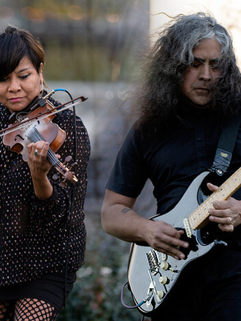 Musicians Laura Ortman (White Mountain Apache) and  Raven Chacon (Navajo) play violin and electric guitar outdoors.