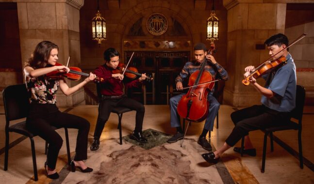 A student quartet gathers to play in the USC library.