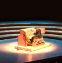 Photo of Thomas Mellon playing pipe organ on stage at Walt Disney Concert Hall.