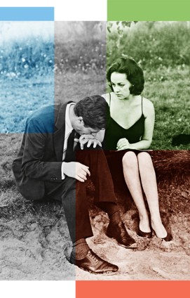 A man and woman sit on a sandy dune in formal attire.