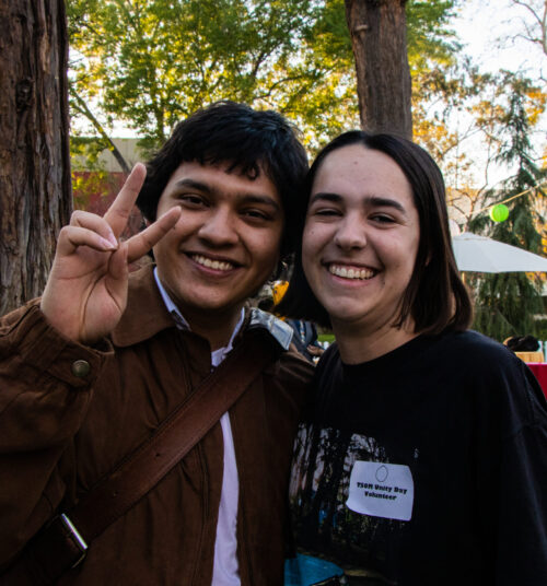 Two students outdoors at Unity Day demonstrating the USC 