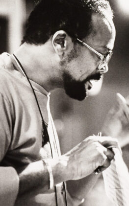 Quincy Jones mid-gesture, conducting