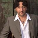 Headshot of Richard Smith holding an electric guitar.