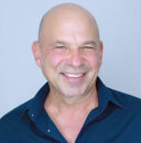 Headshot of Tim Kobza smiling at the camera.