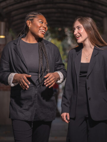Two choristers talk on a brick path