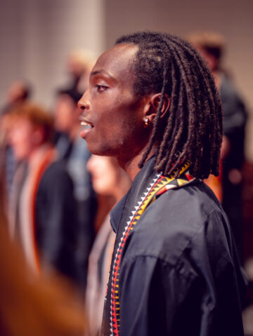 Choristers sing onstage.