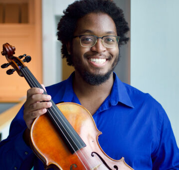 Image of student holding a viola.