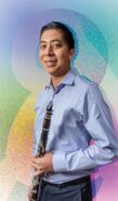 Photo of a music student in front of a colorful graphic background for the Classical ReDesign.